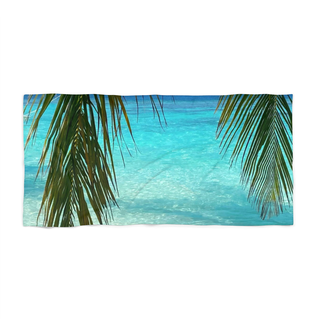 Palm Frond Lagoon beach towel laid flat: palm fronds framing clear turquoise lagoon water