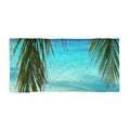 Palm Frond Lagoon beach towel laid flat: palm fronds framing clear turquoise lagoon water