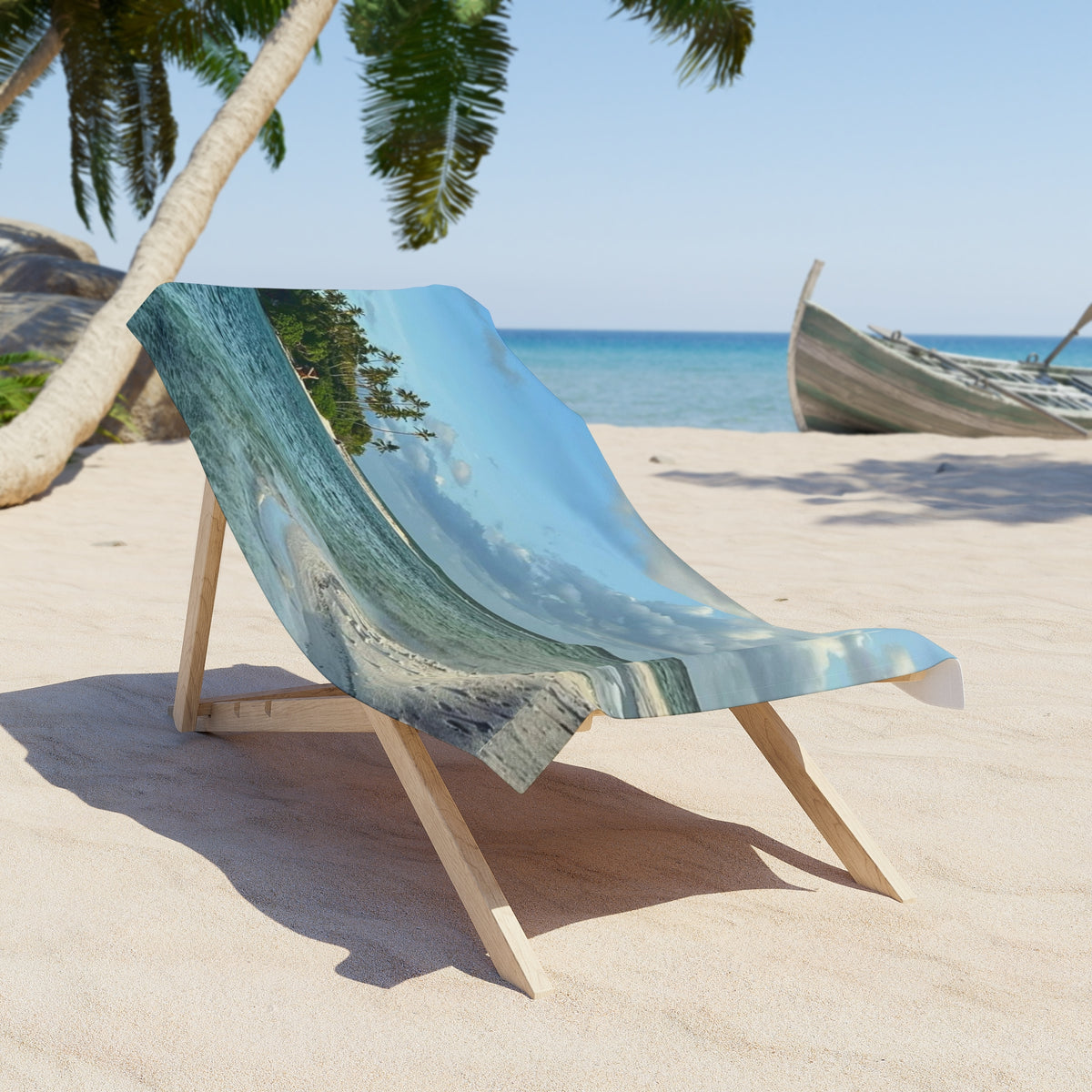 Palm Island Shallows beach towel draped over a wooden beach chair on the sand (chair not included)