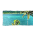 Turquoise Bay Palms beach towel laid flat: tall palm over bright turquoise water with green hills on the far shore