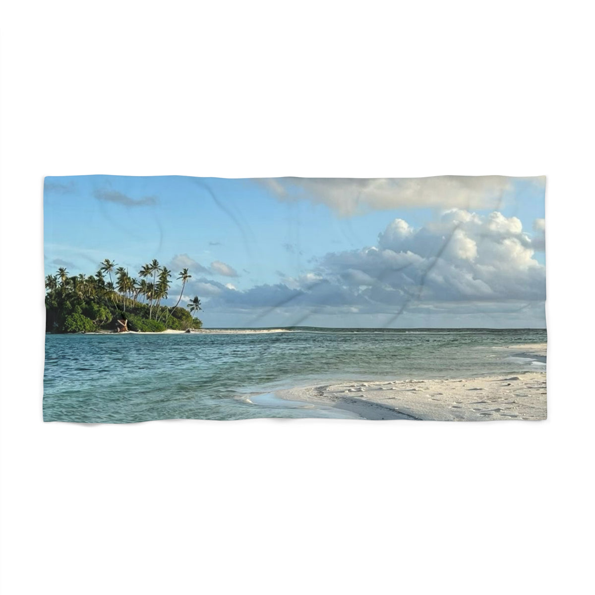 Palm Island Shallows beach towel laid flat: small palm-covered island on the horizon above clear, sandy shallows and white clouds