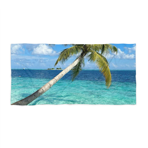 Island Horizon Palm beach towel laid flat: a single palm leaning over turquoise water with a small island on the horizon