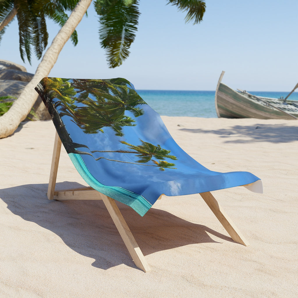 Leaning Palms Seaside beach towel draped over a wooden beach chair on the sand; chair and scenery not included