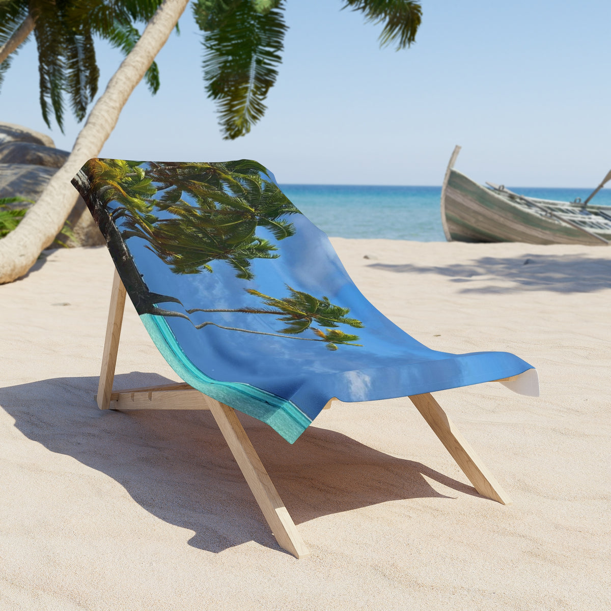 Leaning Palms Seaside beach towel draped over a wooden beach chair on the sand; chair and scenery not included